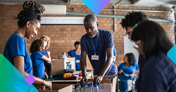Volunteers in blue shirts packaging water
